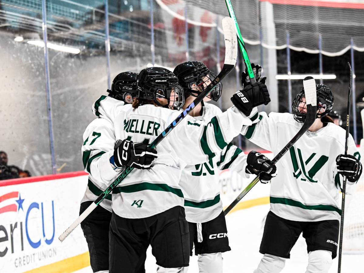 Members of PWHL Boston celebrate a goal during a pre-season game in Utica.