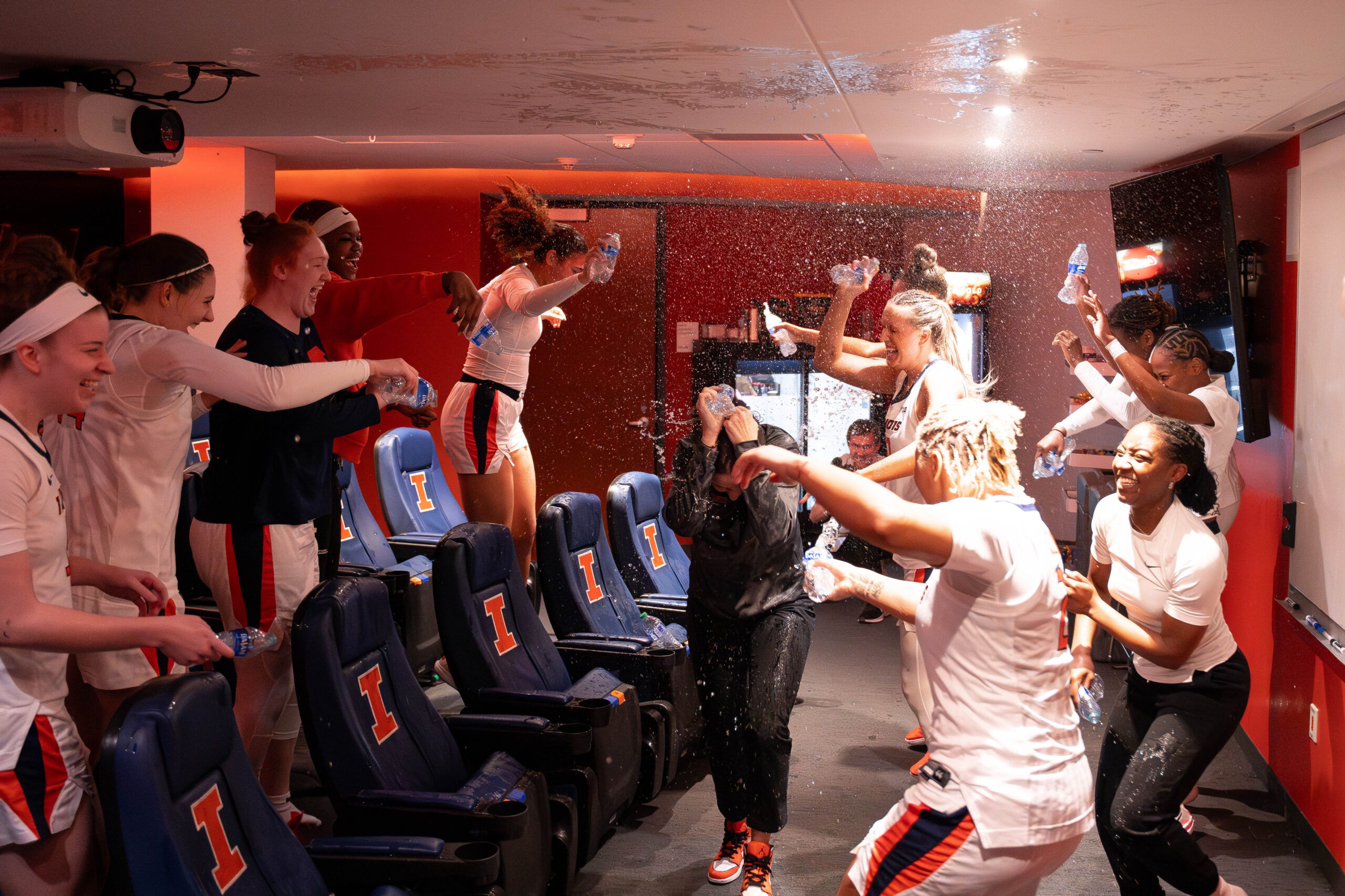 Illinois players douse head coach Shauna Green with water in the locker room after their upset of Indiana.