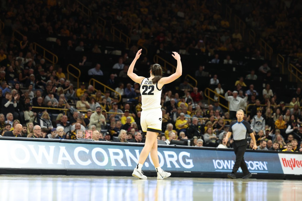 Caitlin Clark pumps up the crowd at Carver-Hawkeye Arena.