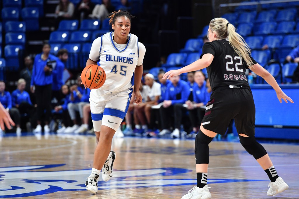 Saint Louis' Brooklyn Gray dribbles up the court with her right hand as Missouri State's Paige Rocca defends with her arms out.