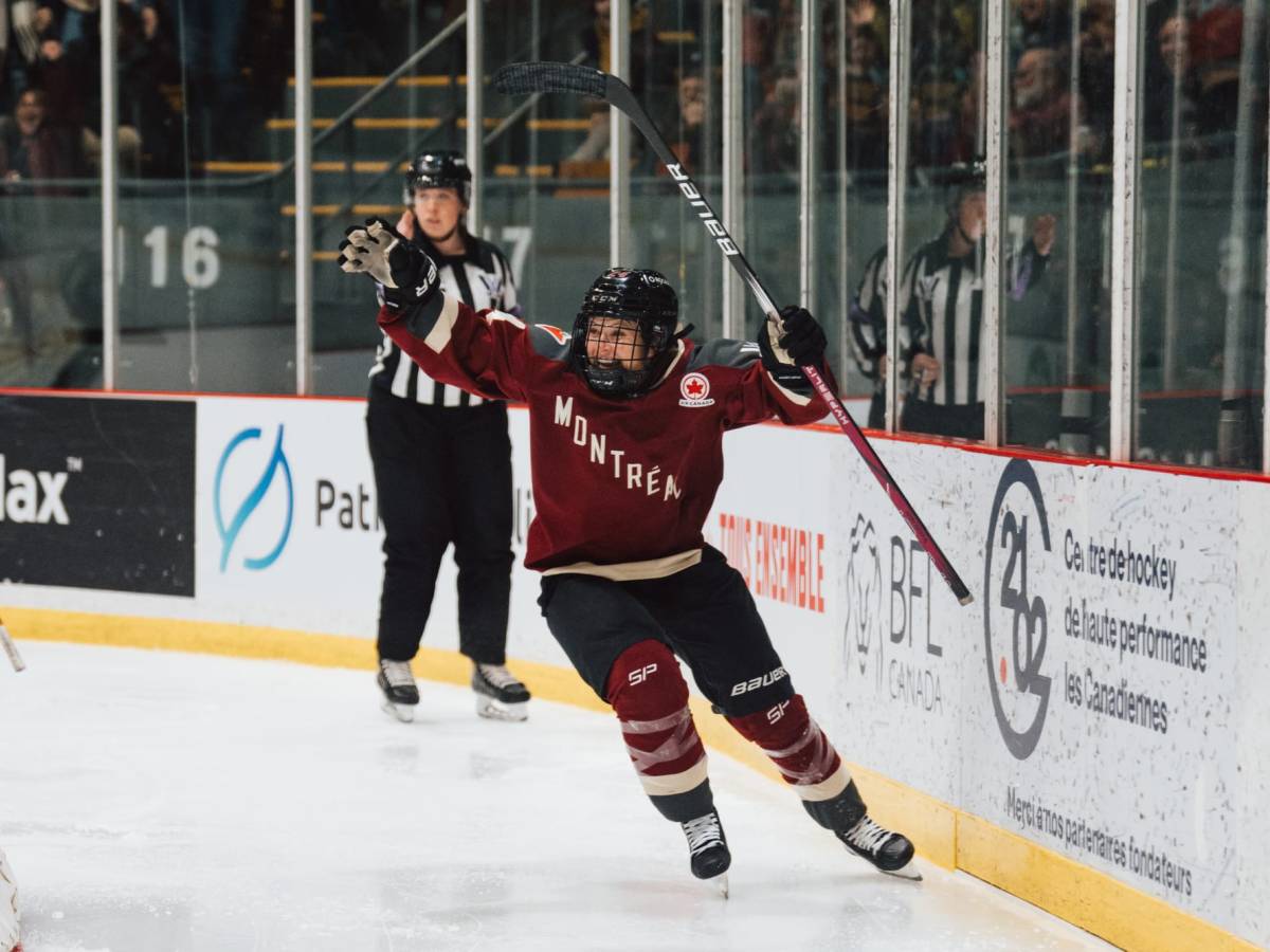 Ann-Sophie Bettez throws her hands in the air to celebrate her goal against Ottawa. She is wearing her maroon home uniform.