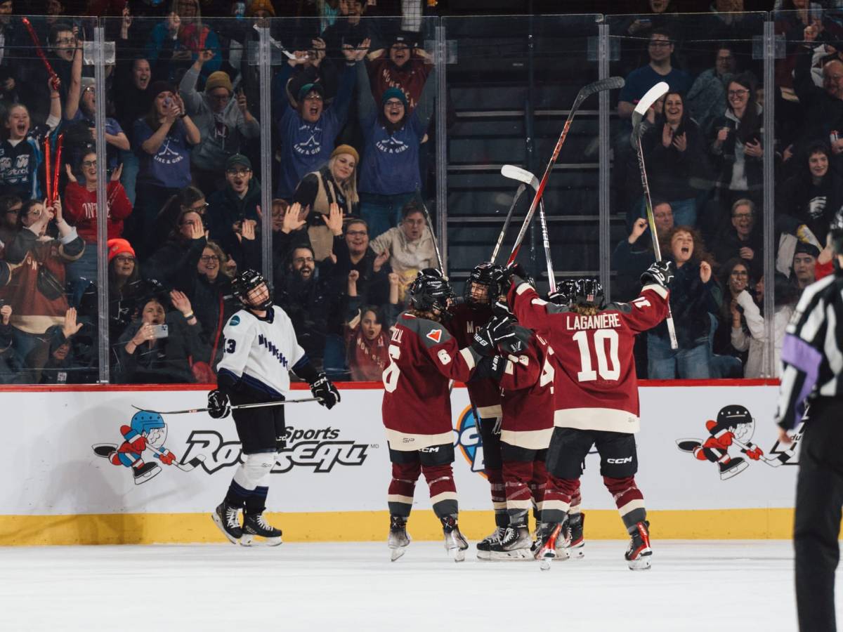 Montréal players, wearing their maroon home jerseys, celebrate a goal against Minnesota.