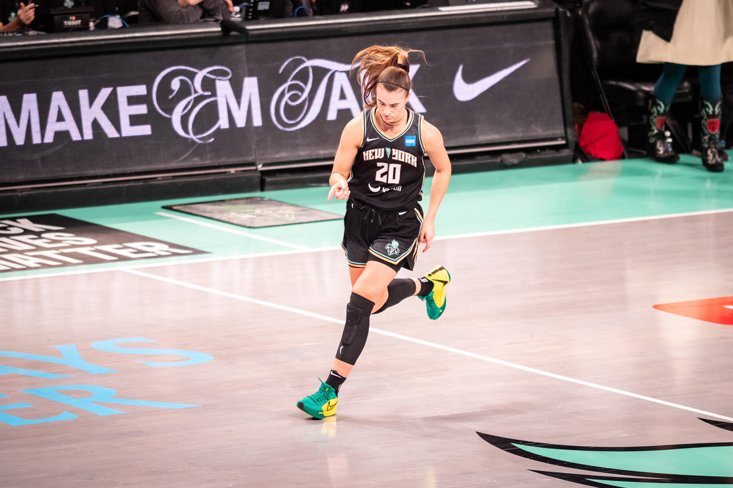 Sabrina Ionescu points to the court.