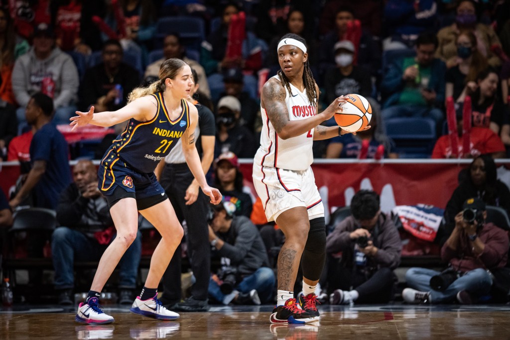 Indiana Fever forward Emily Engstler extends her right arm into a passing lane as Washington Mystics forward Myisha Hines-Allen looks for options with her back to the basket.
