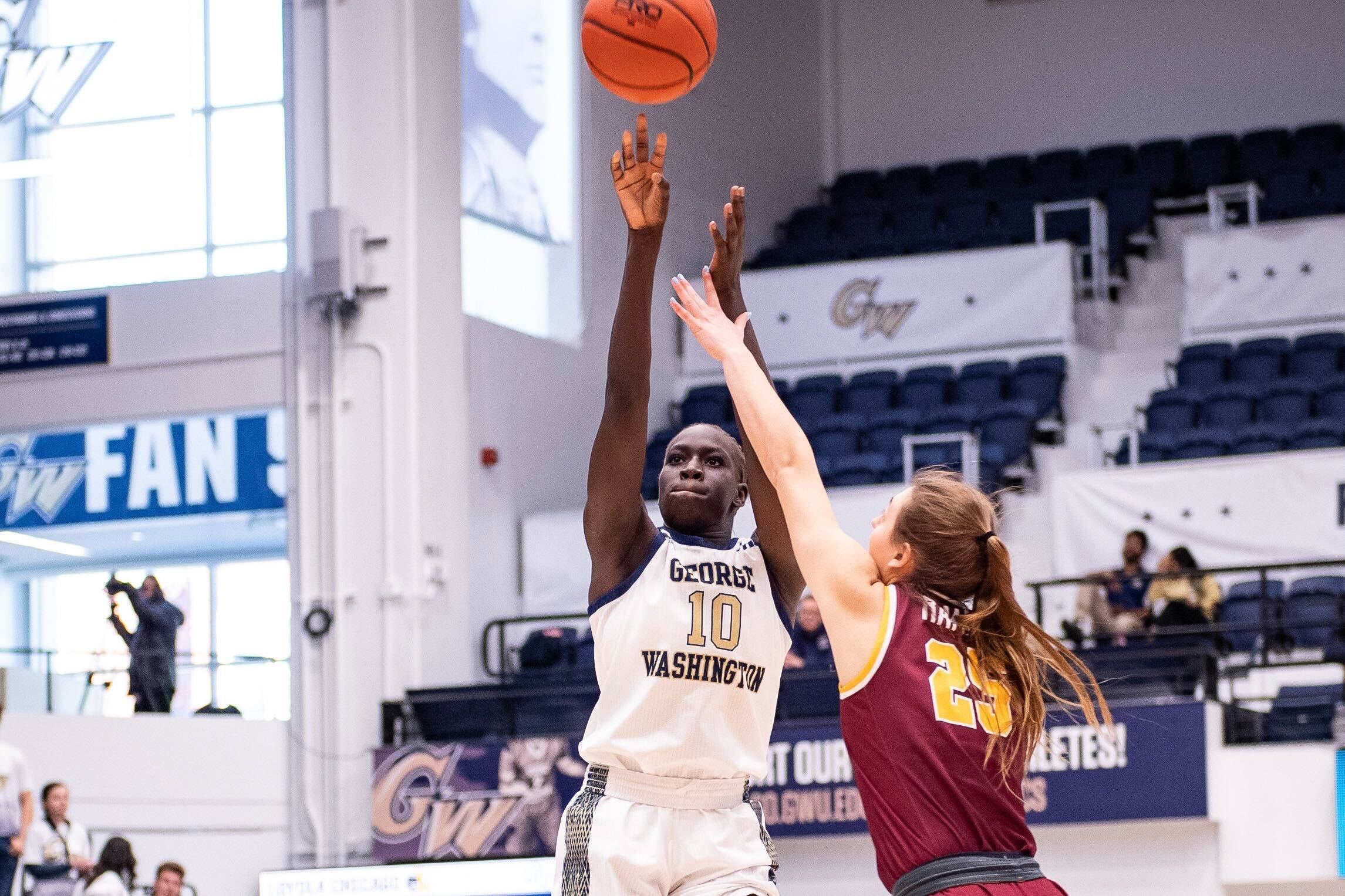 George Washington's Nya Lok shoots over a Loyola Chicago defender.