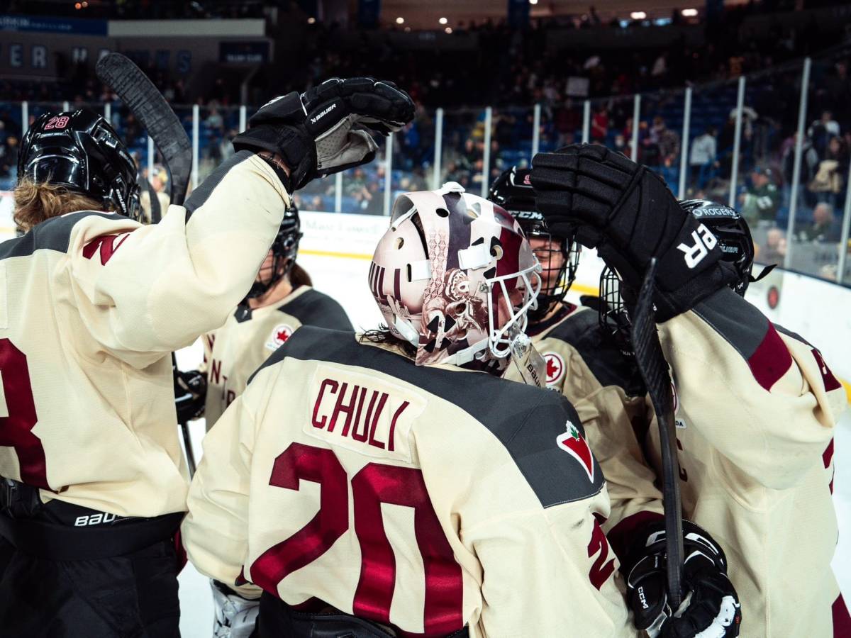 In their cream away uniforms, teammates celebrate with Elaine Chuli after their win against Boston.