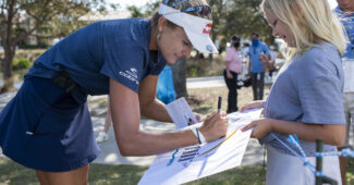 Lexi Thompson signs an autograph for a young fan.