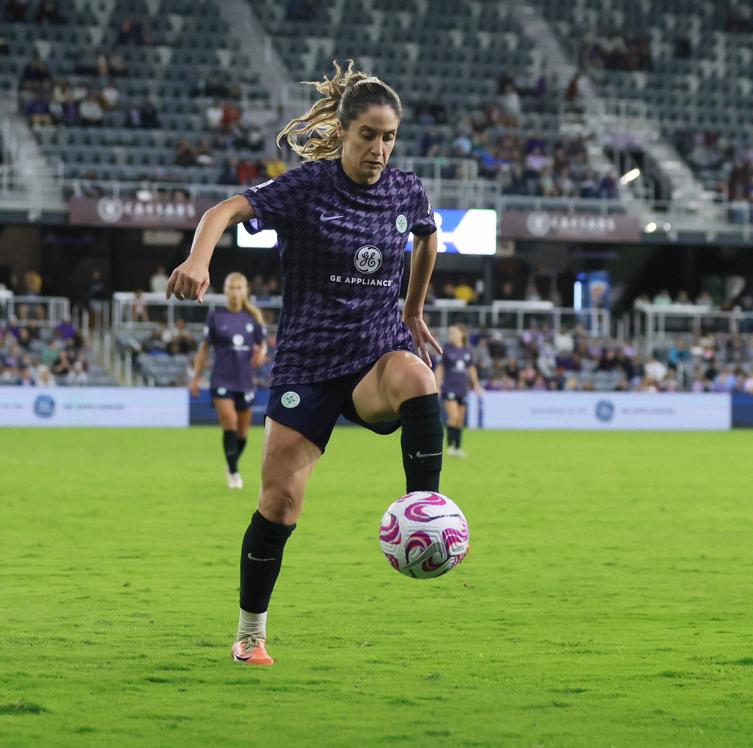 Racing Louisville FC midfielder Savannah DeMelo handles the soccer ball