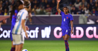 Jaedyn Shaw raises her hand before taking a kick against Argentina during the CONCACAF W Cup