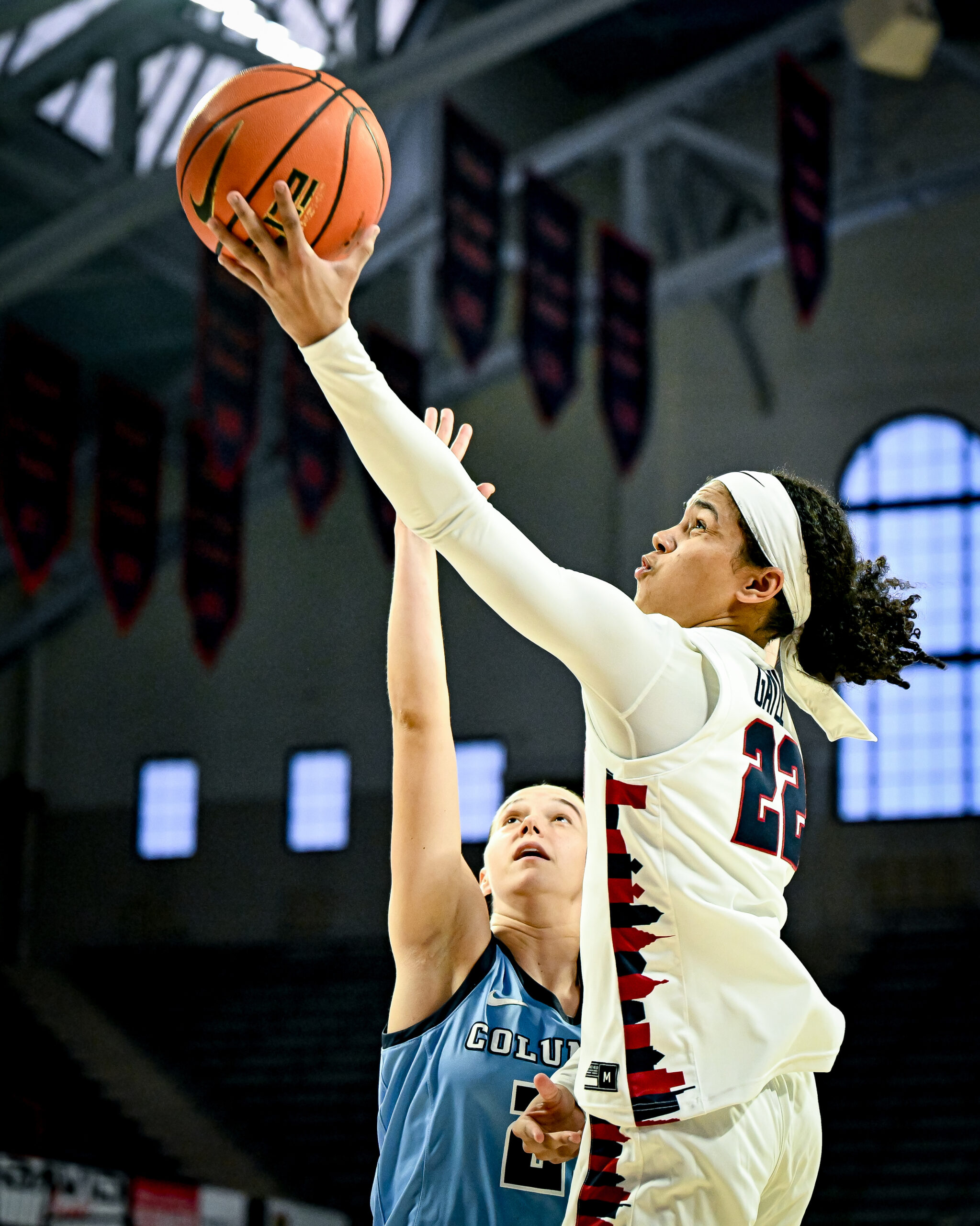 Penn guard Mataya Gayle extends her left arm to shoot a layup as a Columbia defender arrives too late to contest.