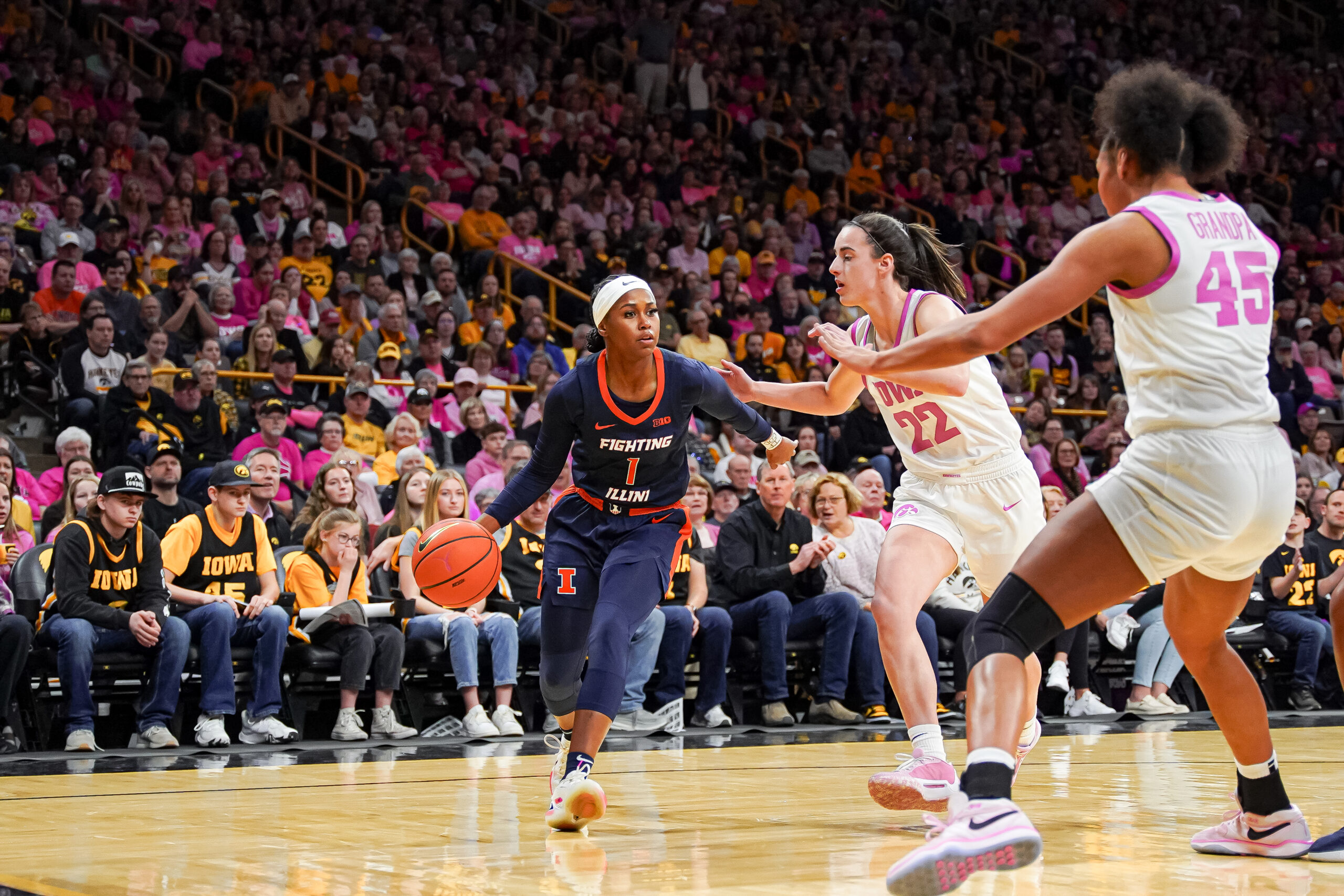 Genesis Bryant dribbles the ball for Illinois against Caitlin Clark