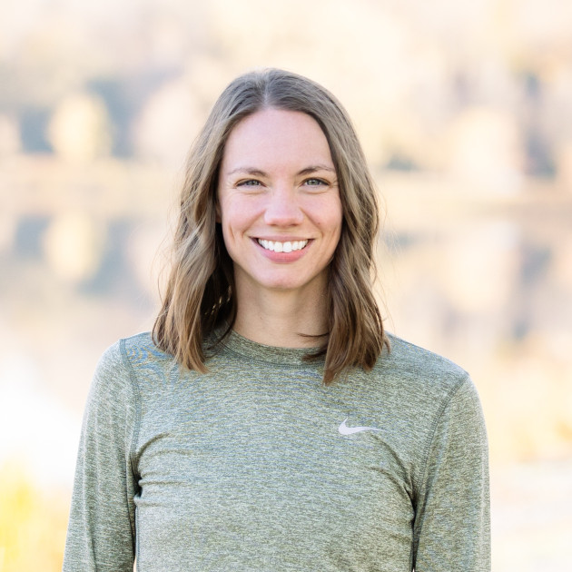Former gymnast Gabi Rooker will compete in the US Marathon trials. Rooker is pictured in a gray Nike top against a green background.