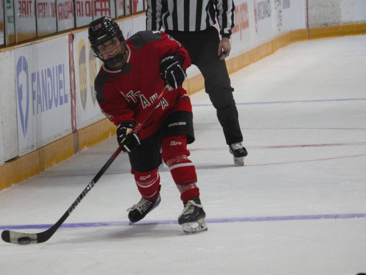 Amanda Boulier in a red Ottawa jersey takes a shot