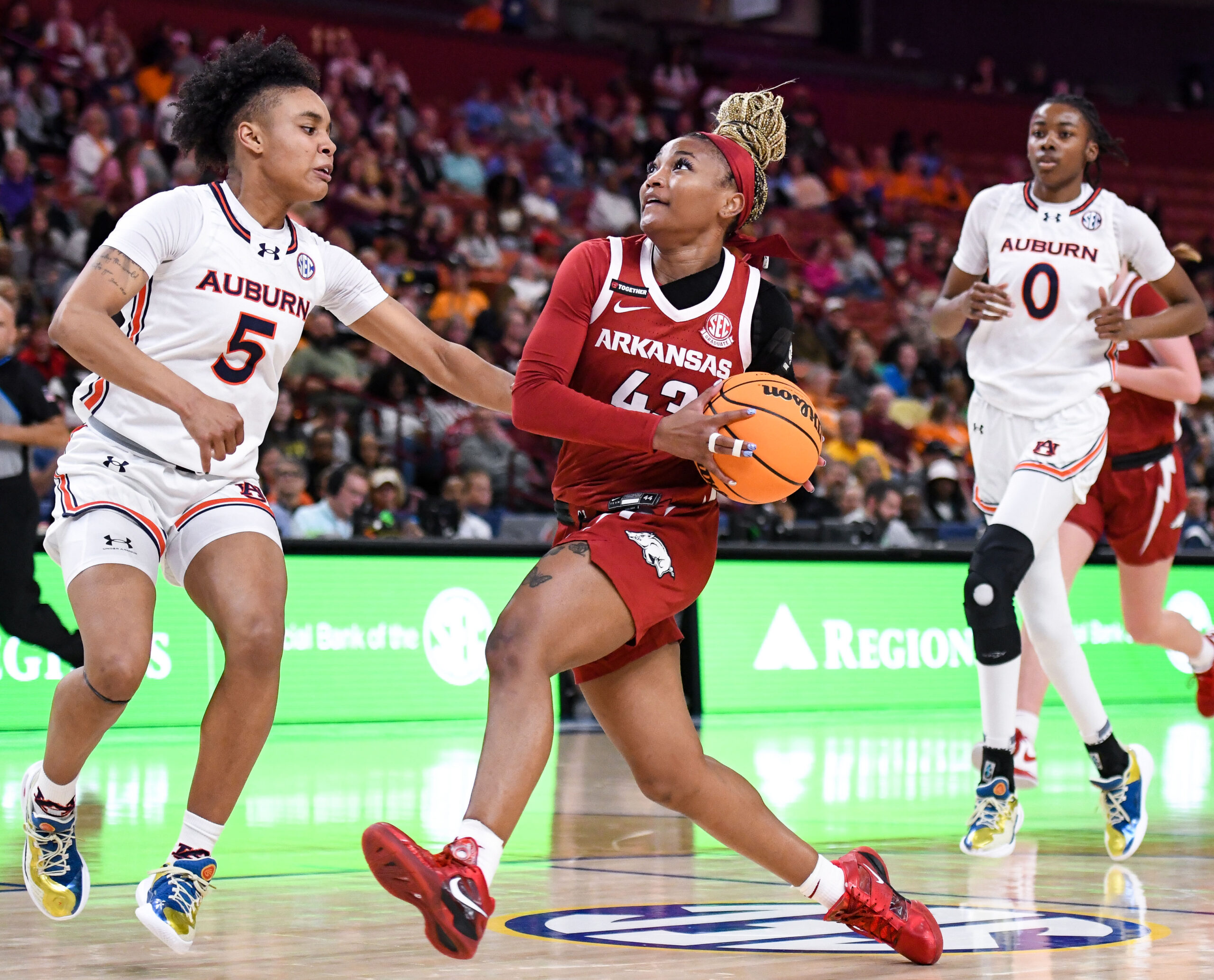 Arkansas guard Makayla Daniels protects the ball as she gets ready to elevate for a shot by holding it on the left side of her body, away from an approaching defender.