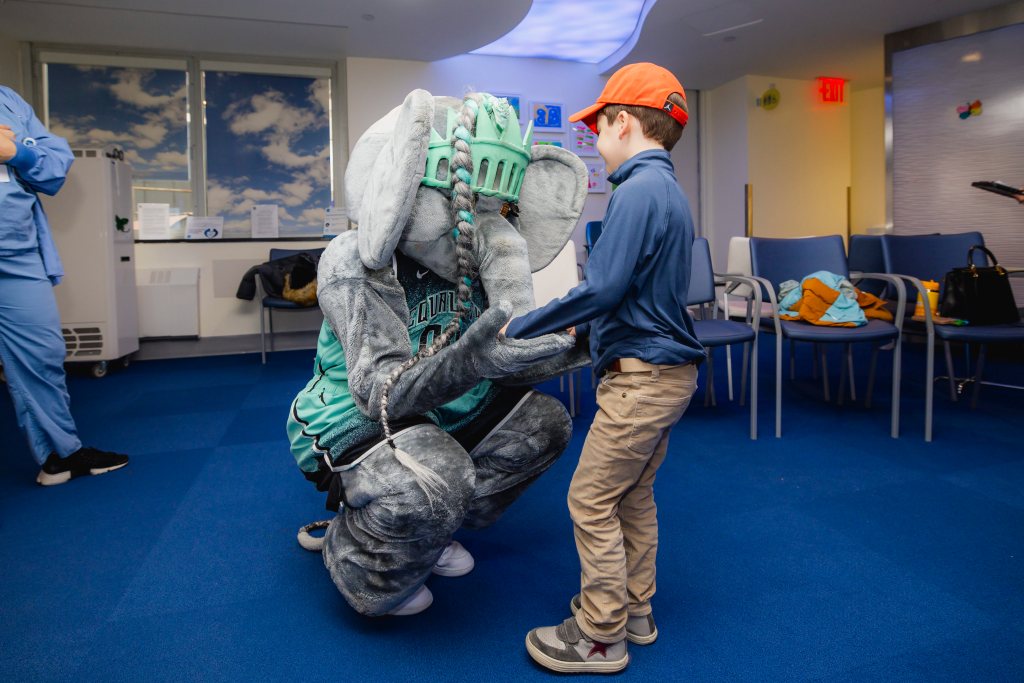 Ellie interacts with a child named Oliver at HSS.