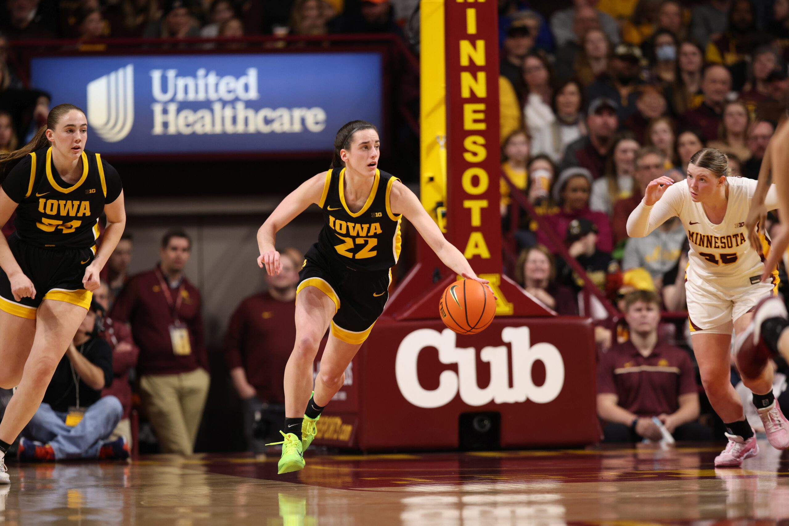 Iowa's Caitlin Clark dribbles up the floor with her left hand against Minnesota.