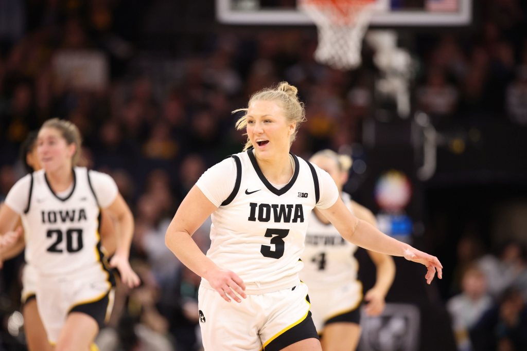 Sydney Affolter of Iowa smiles as she runs up the court after a shot.