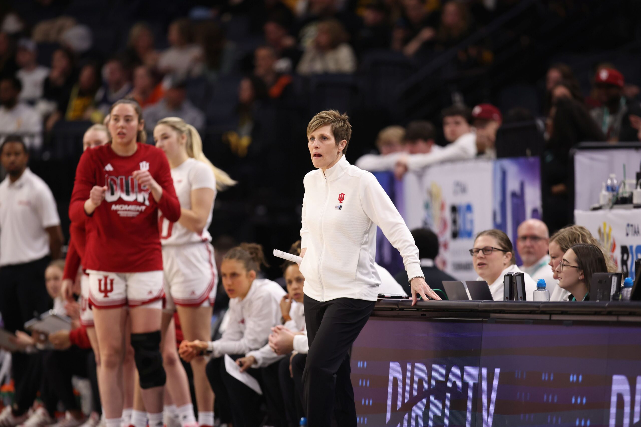 Teri Moren stands on the sideline with Mackenzie Holmes in the background during Indiana's quarterfinal against Michigan in the 2024 Big Ten Tournament.