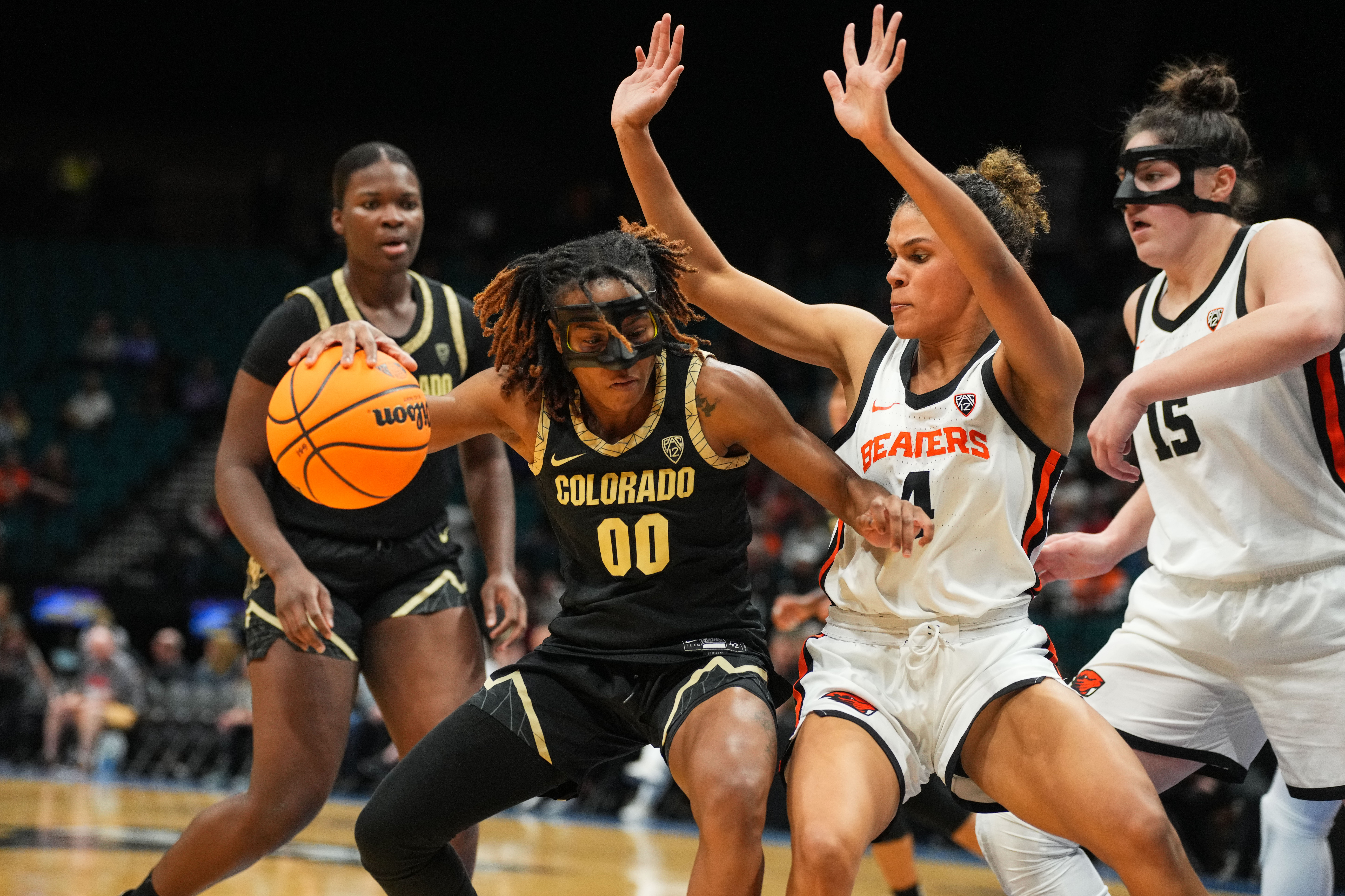 Colorado's Jaylyn Sherrod dribbles the ball with her right hand, trying to get to the rim, as Oregon State's Donovyn Hunter provides resistance.