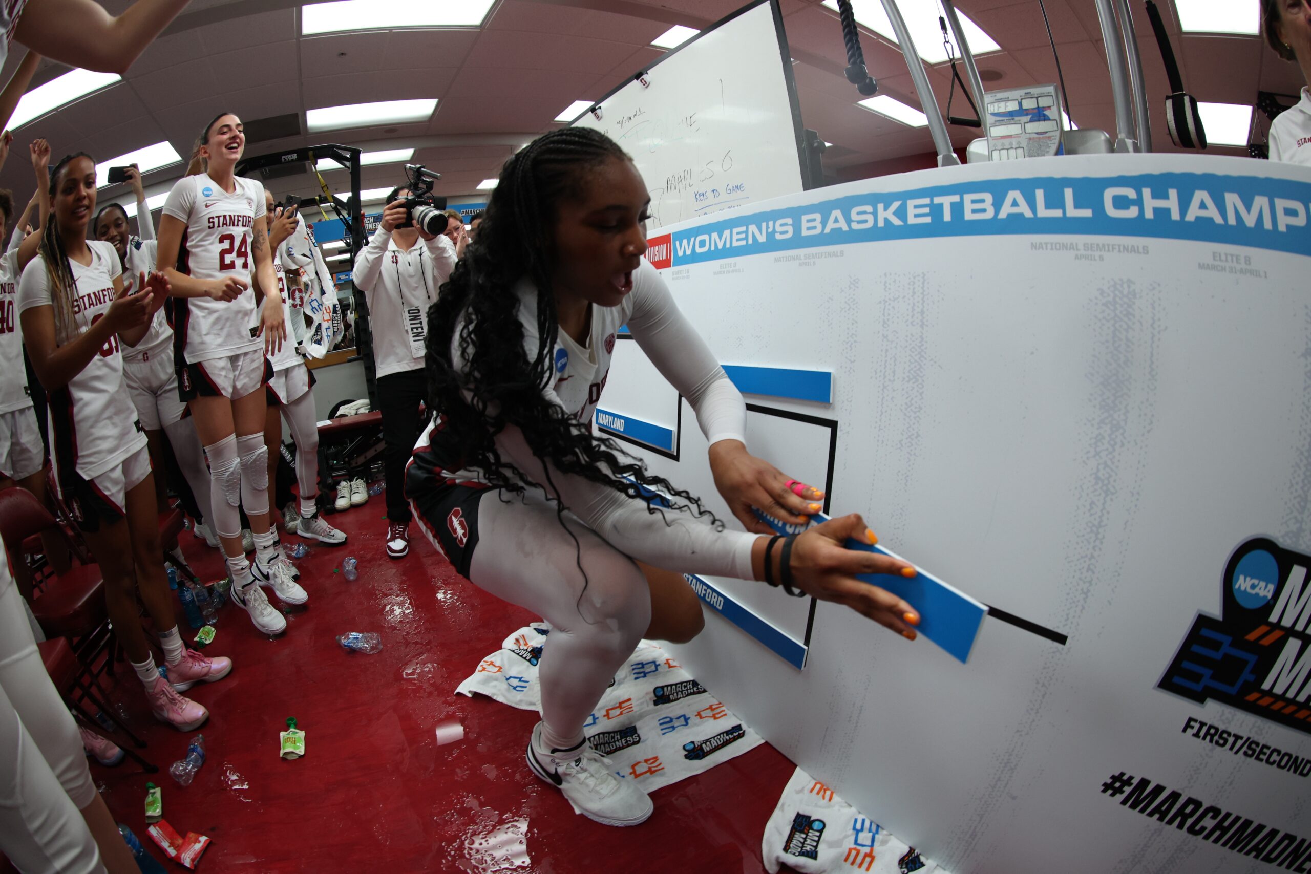 Junior forward Kiki Iriafen places Stanford's nameplate on the bracket after scoring 41 points to lead the Cardinal to an 87-81 overtime win over Iowa State in the second round of the NCAA Tournament on Sunday, March 24, 2024 at Maples Pavilion in Stanford, Calif. (Photo courtesy of Stanford Athletics)