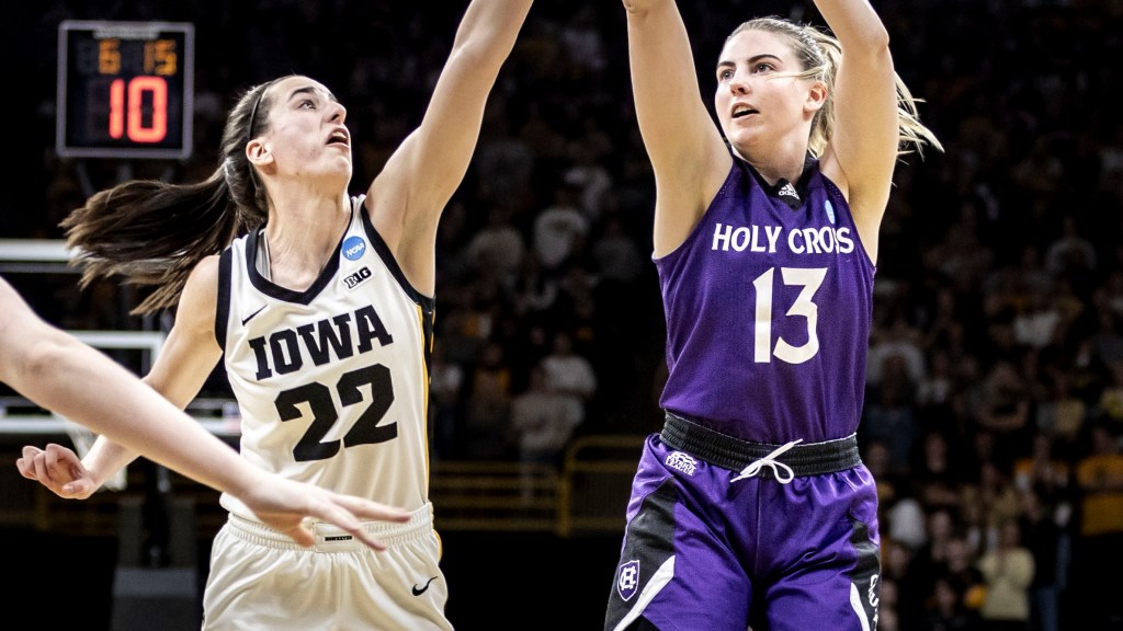Holy Cross guard Bronagh Power-Cassidy shoots over Iowa guard Caitlin Clark in their NCAA Tournament first-round matchup