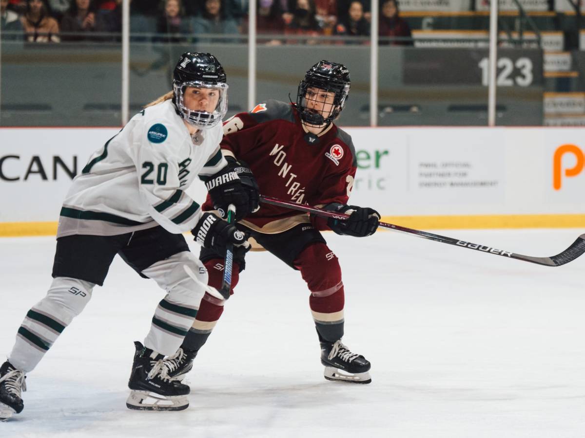 Hannah Brandt battles for positioning with Sarah Bujold. Brandt is wearing white, while Bujold is in maroon.