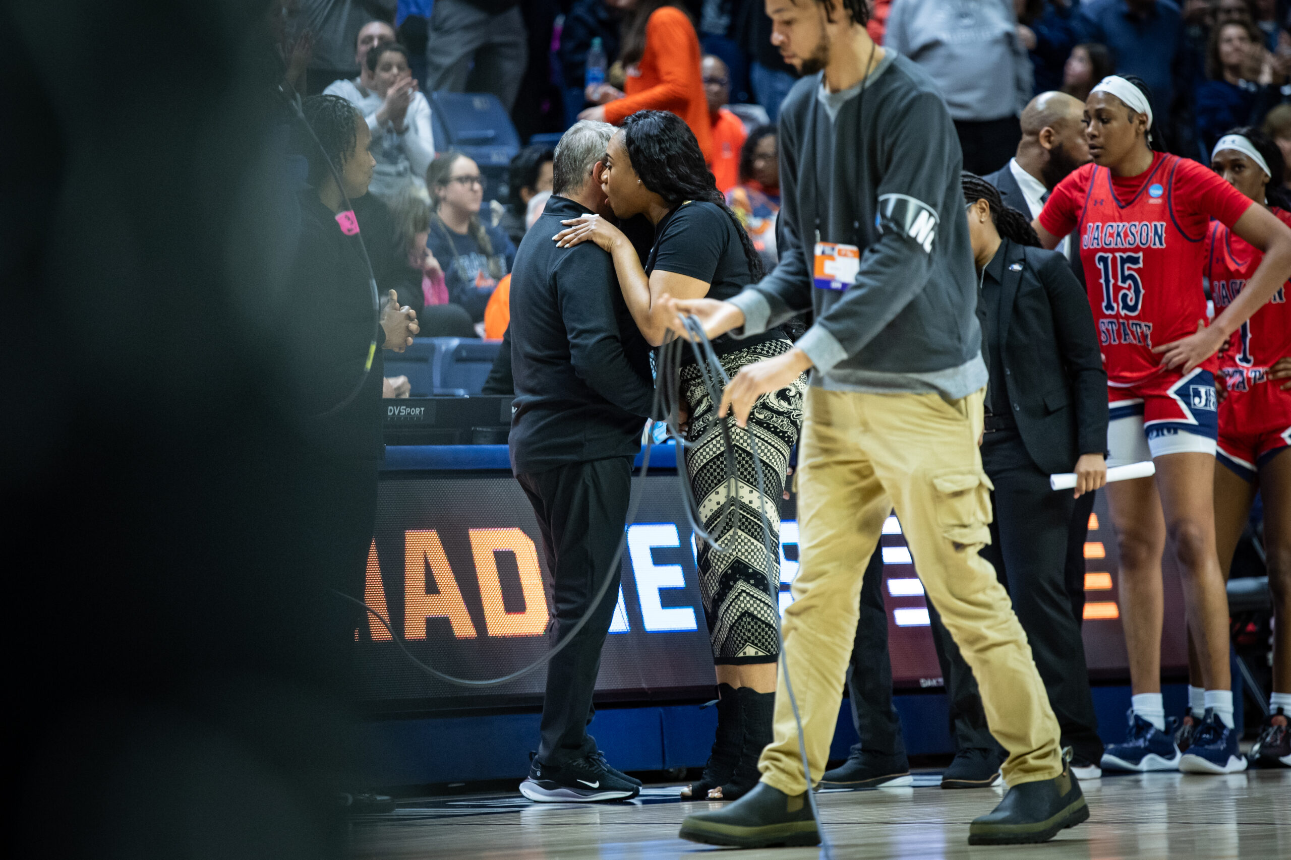 Geno Auriemma and Tomekia Reed share words following UConn's win over Jackson State in the first round of the NCAA Tournament.
