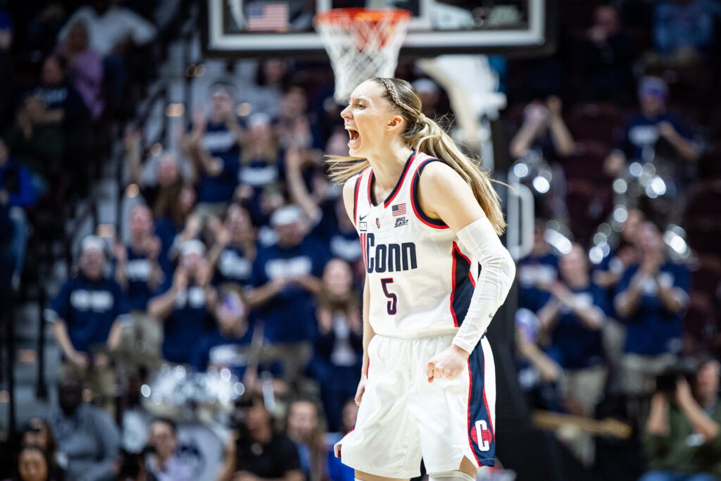 Paige Bueckers screams in celebration in a solo shot of her on the court.