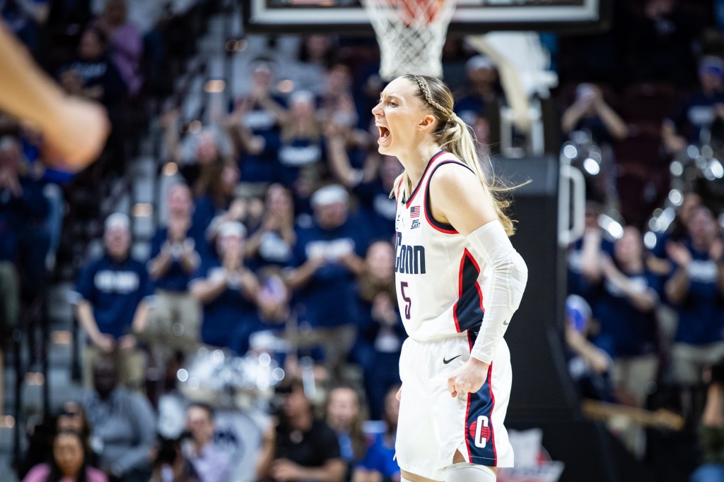 Paige Bueckers celebrates with a yell and a clenched fist