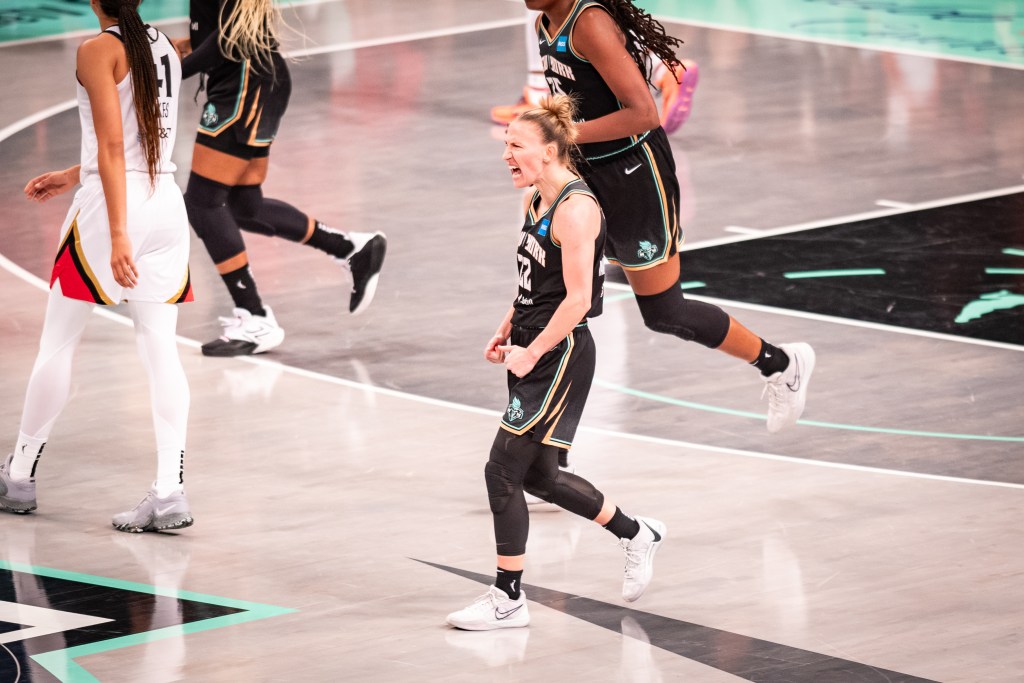 Courtney Vandersloot pumps her first