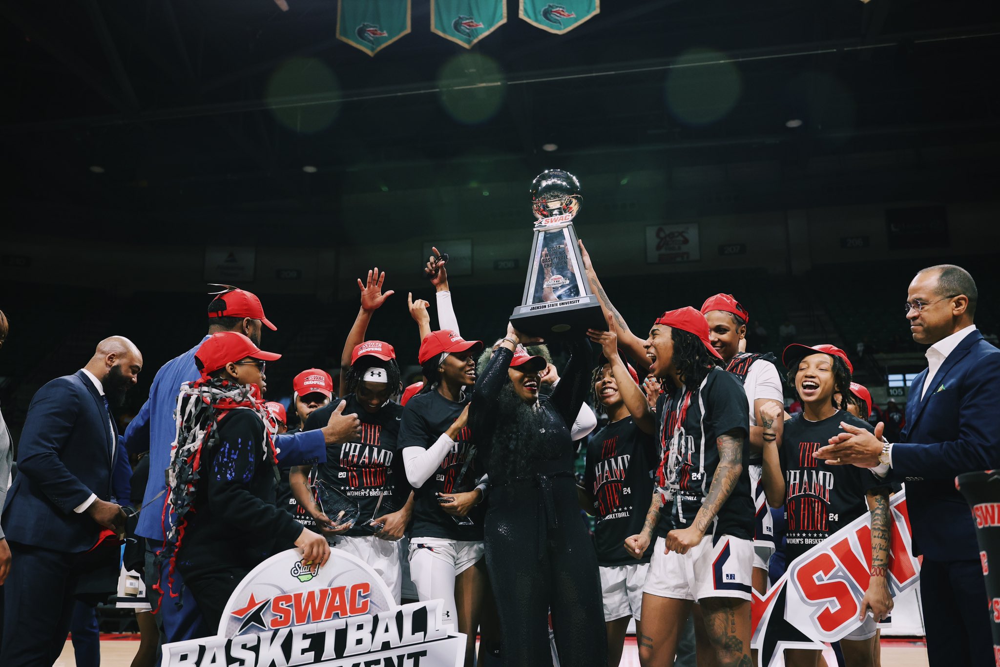 Jackson State players and coaches hold up the SWAC Tournament championship trophy