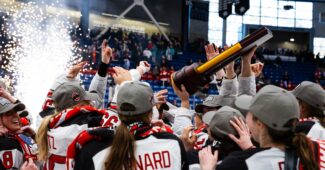 Hockey players from Ohio State hoist championship trophy