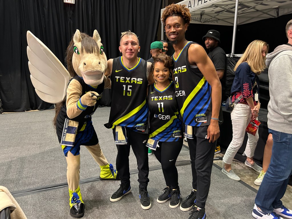 The Dallas Wings mascot and dance team pose for a photograph