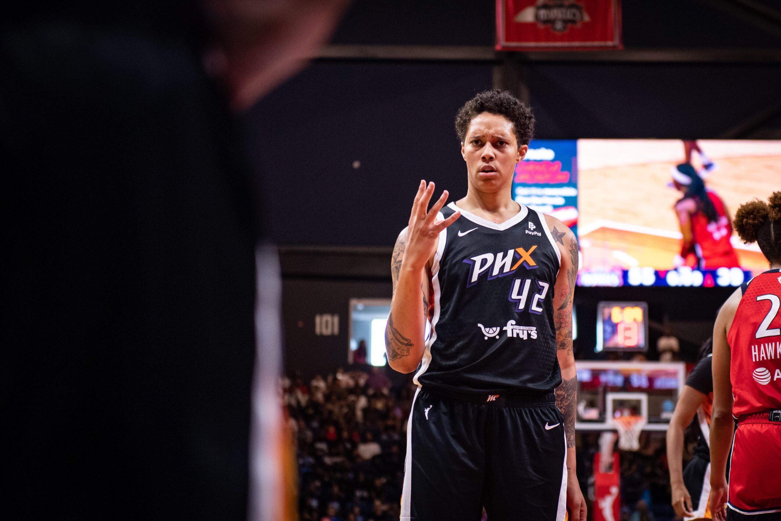 Phoenix Mercury center Brittney Griner holds up four fingers with a confused look on her face.