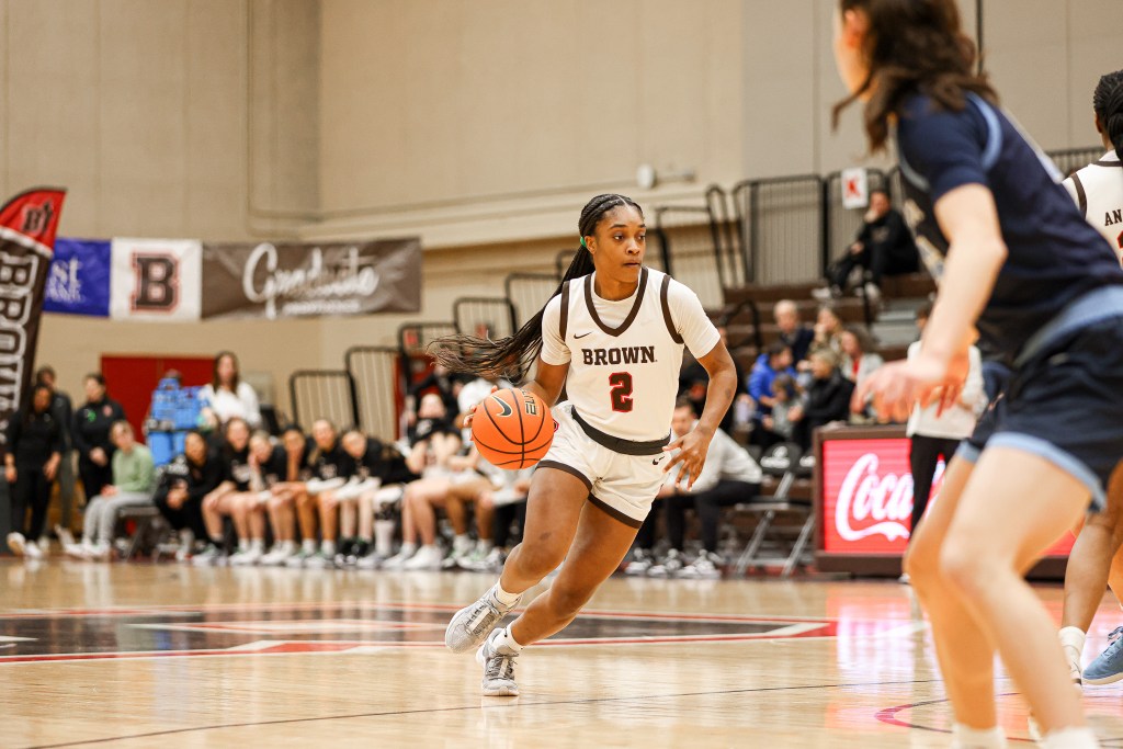 Brown guard Kyla Jones drives the ball with her right hand from outside the 3-point arc.