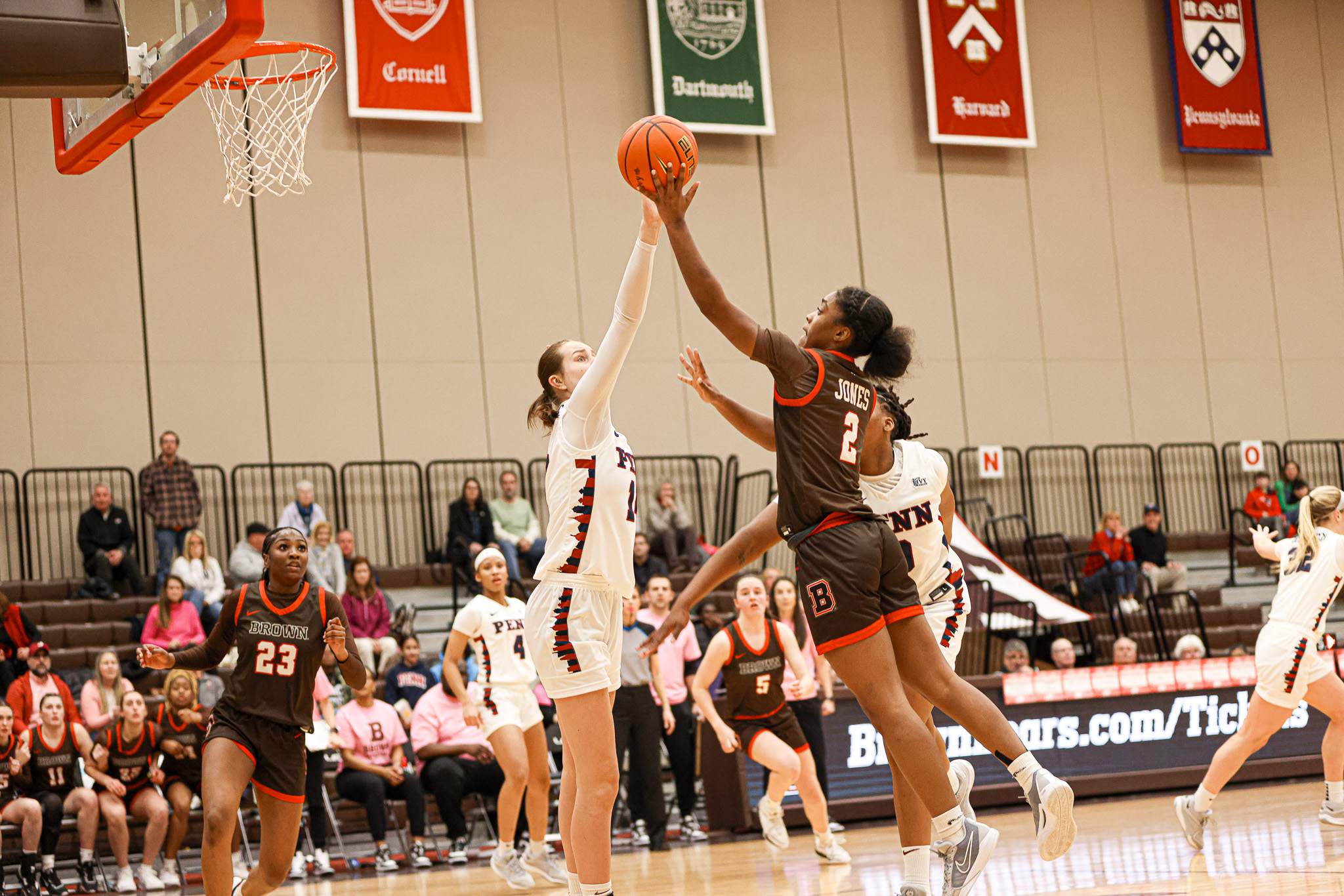 Brown guard Kyla Jones shoots a left-handed layup, just over the outstretched arm of Penn forward Floor Toonders, who came over to help.