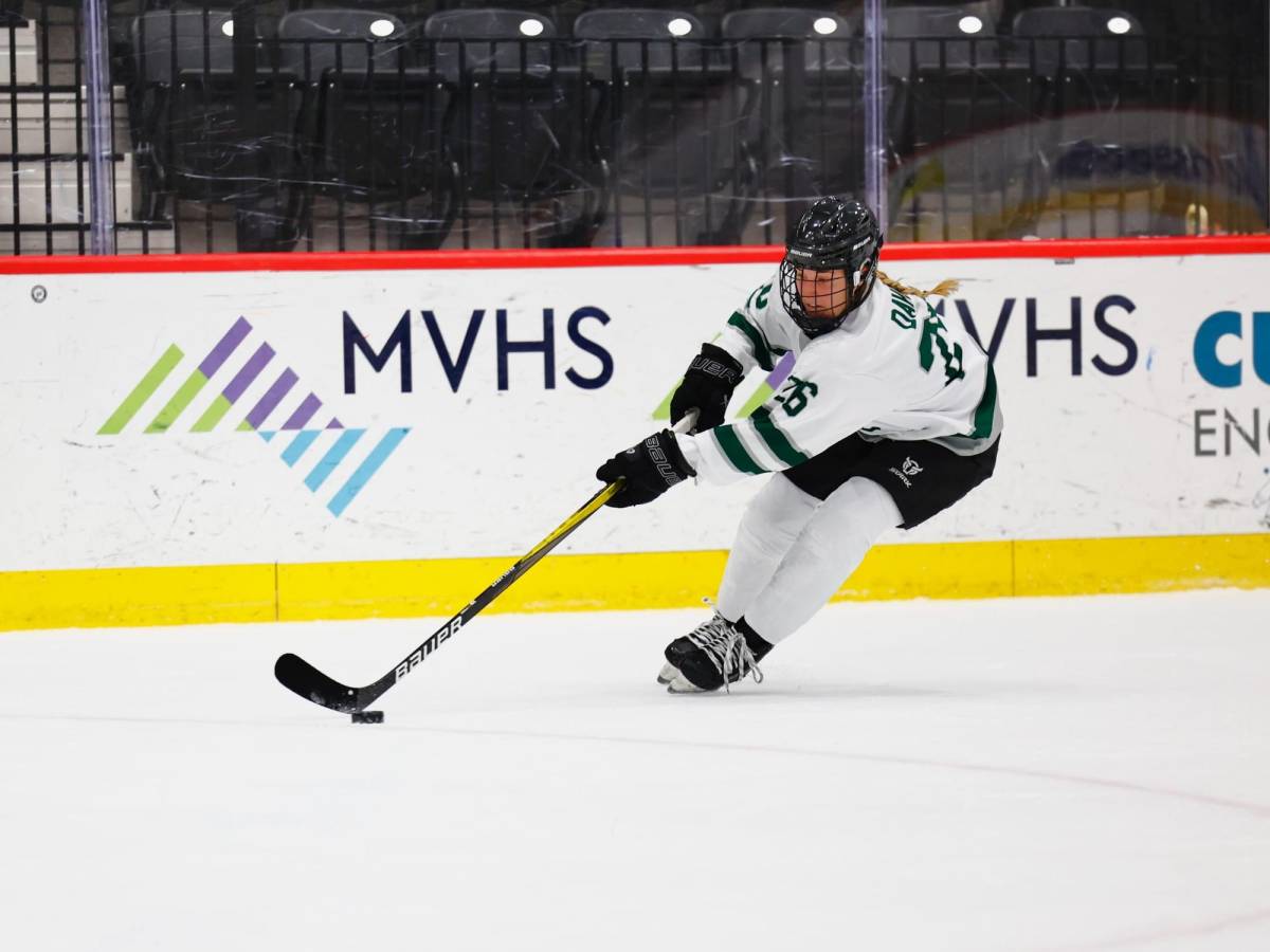 Davis skates with the puck in a PWHL Boston jersey at the pre-season evaluation camp.