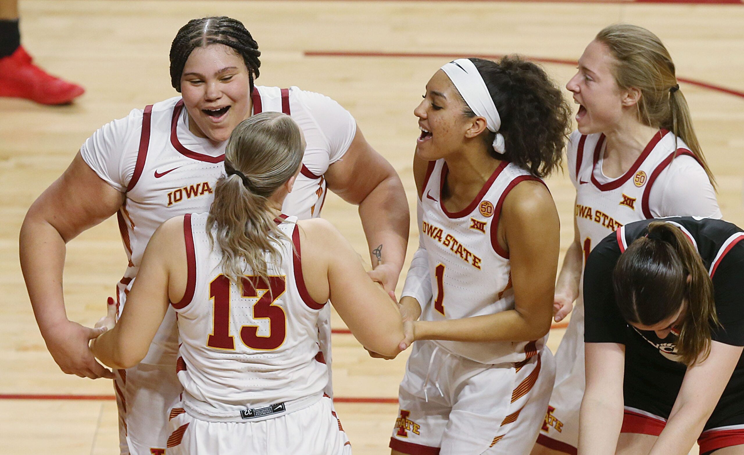 Iowa State Cyclones center Audi Crooks (55), forward Jalynn Bristow (1), and guard Emily Ryan (11) celebrate with guard Hannah Belanger (13) after a four-point play against Cincinnati during the third quarter of a NCAA women's basketball at Hilton Coliseum on March 2, 2024, in Ames, Iowa.