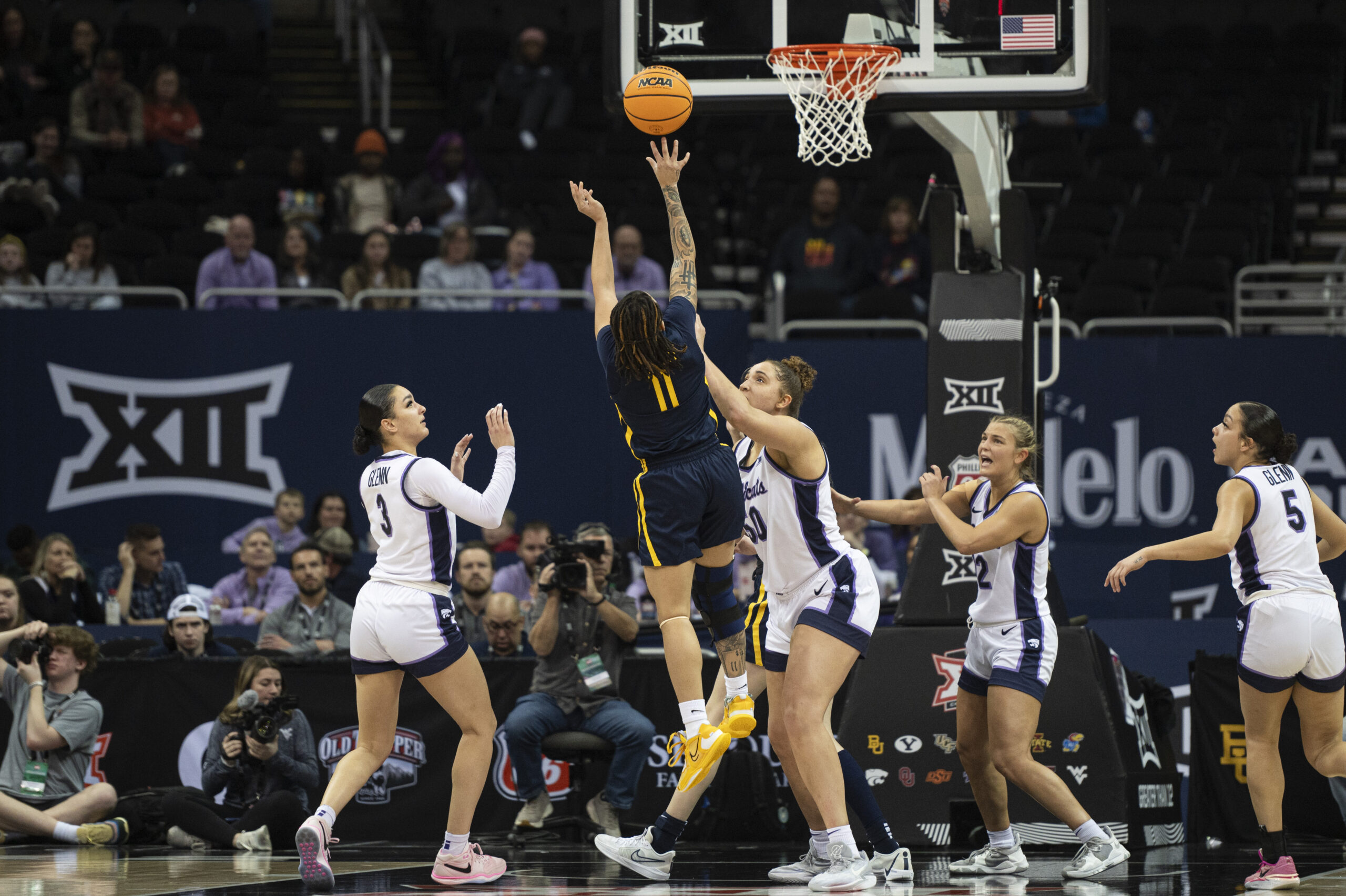 West Virginia guard JJ Quinerly shoots over Kansas State forward Ayoka Lee.