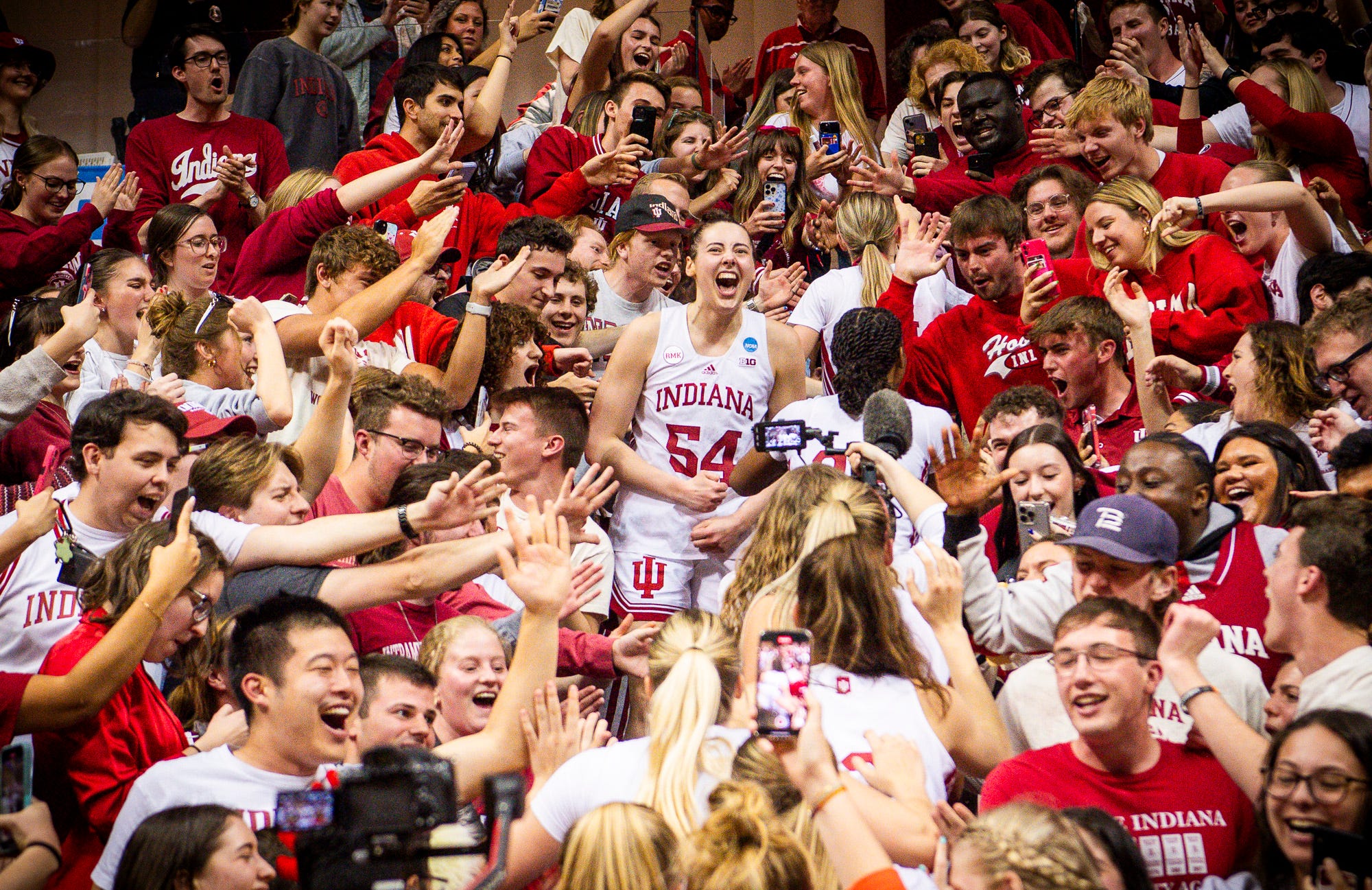 Mackenzie Holmes celebrates in the stands with the student section at Assembly Hall