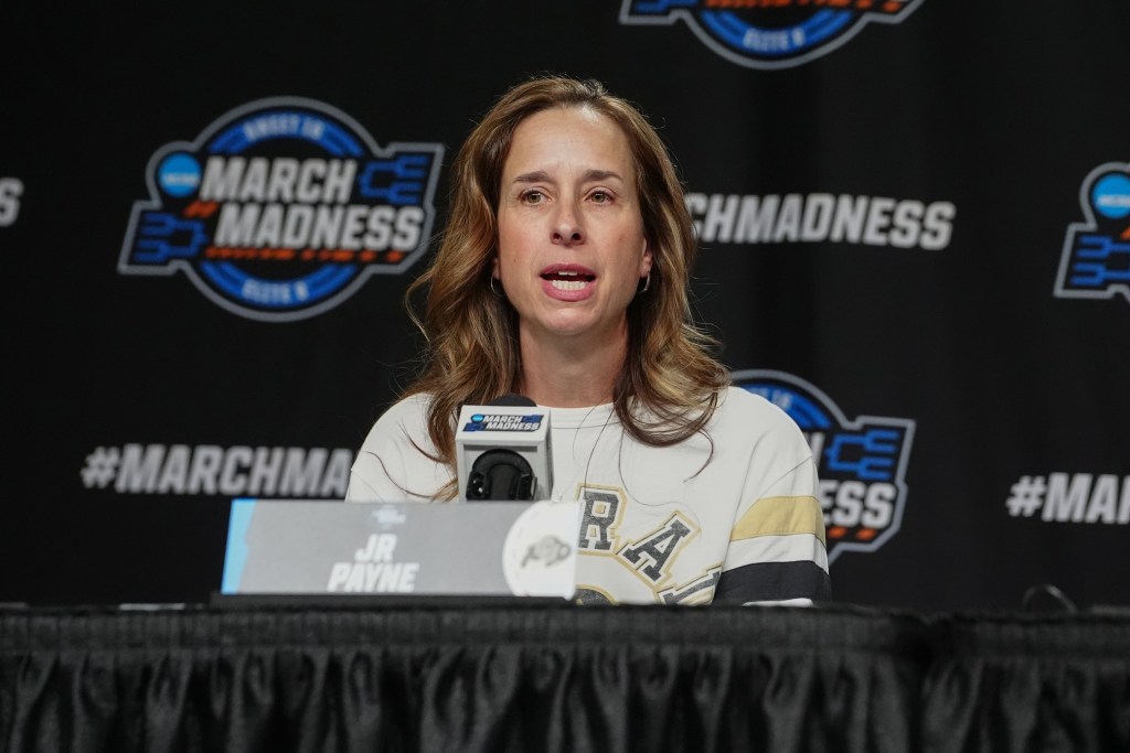 Colorado head coach JR Payne speaks to the media from a podium.