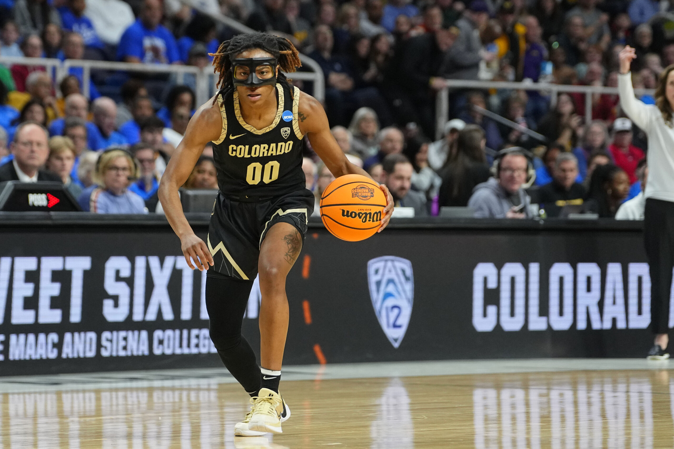 Jaylyn Sherrod, wearing a face mask, drives to the basket during the Sweet 16