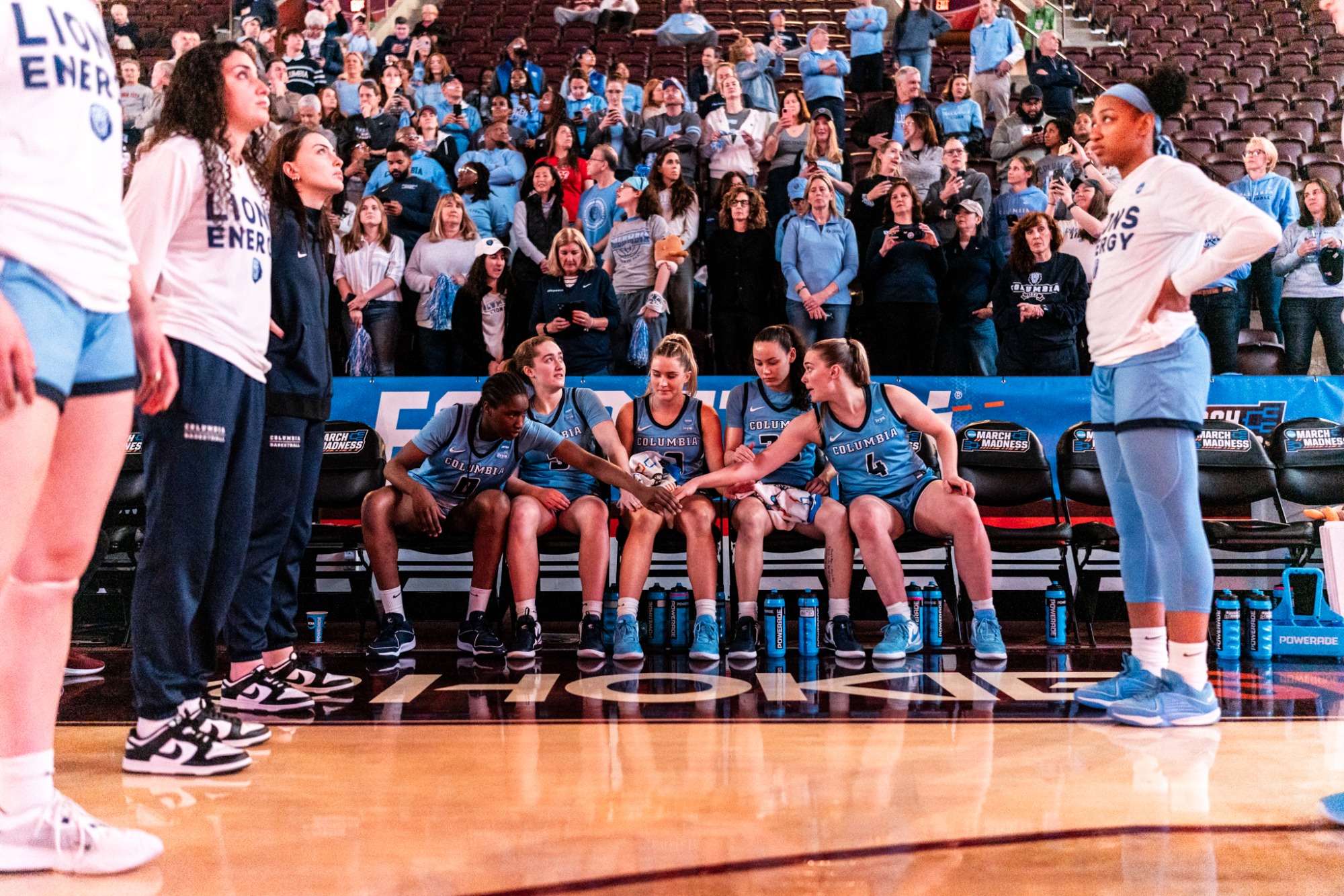 The five Columbia starters sit on the bench and lean toward each other before they are introduced pregame.