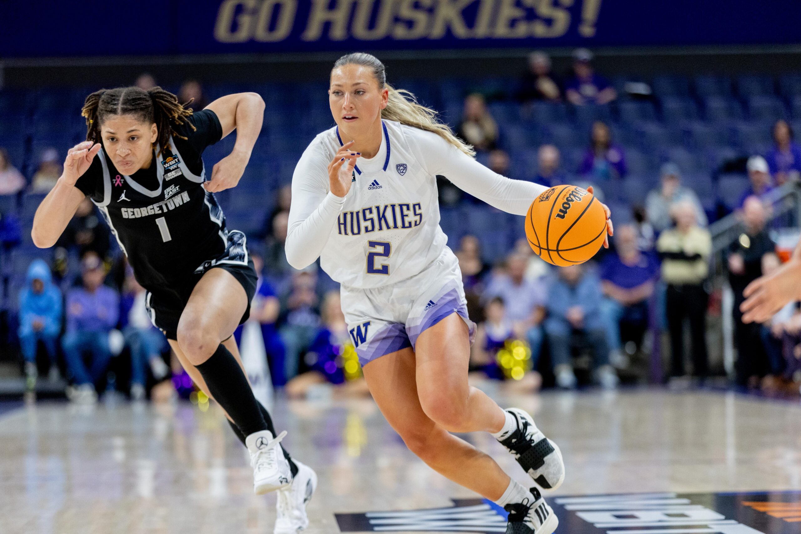 Lauren Schwartz dribbles the basketball at speed while Kelsey Ransom chases back defensively.