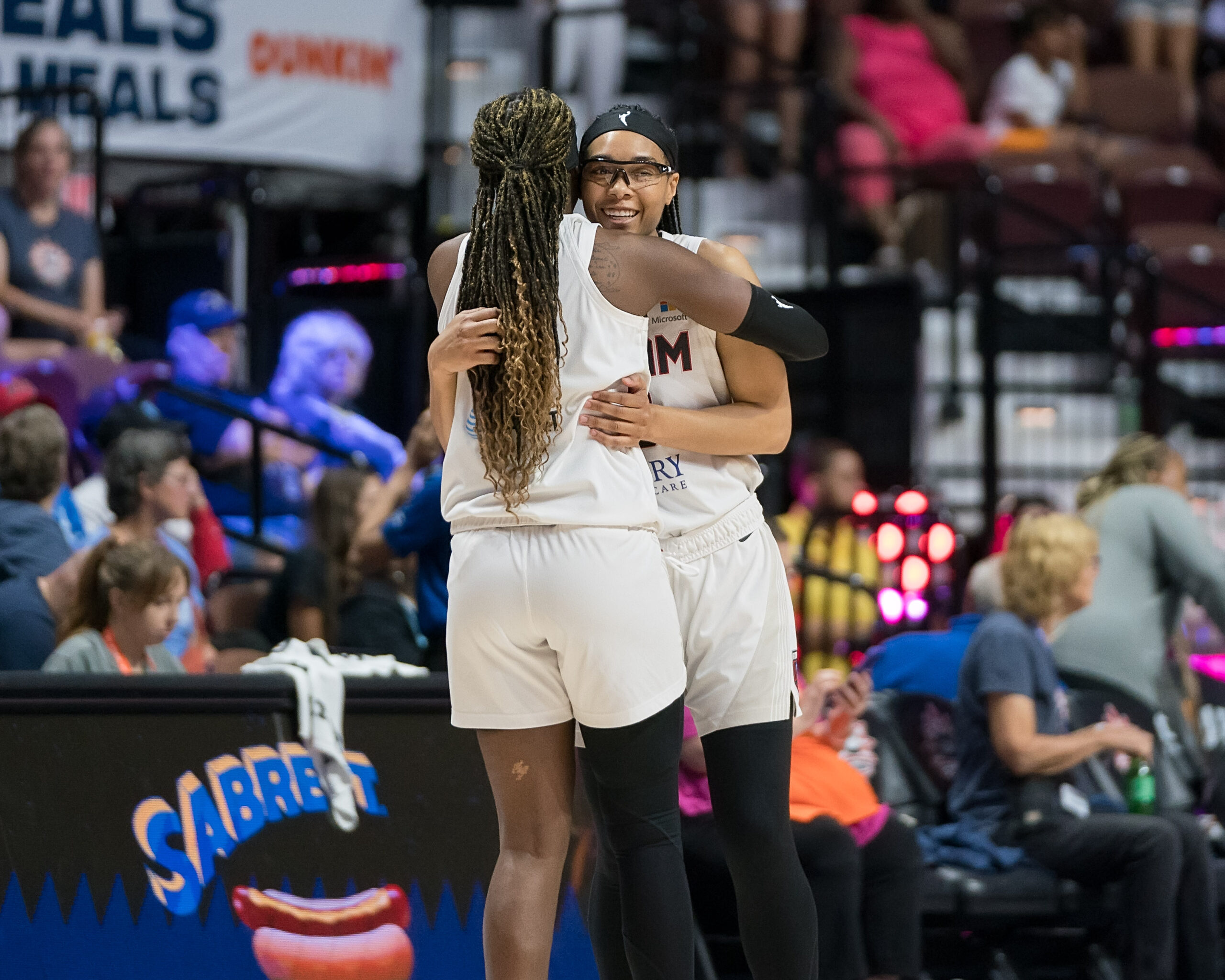 Atlanta Dream guards Rhyne Howard and Allisha Gray hug.