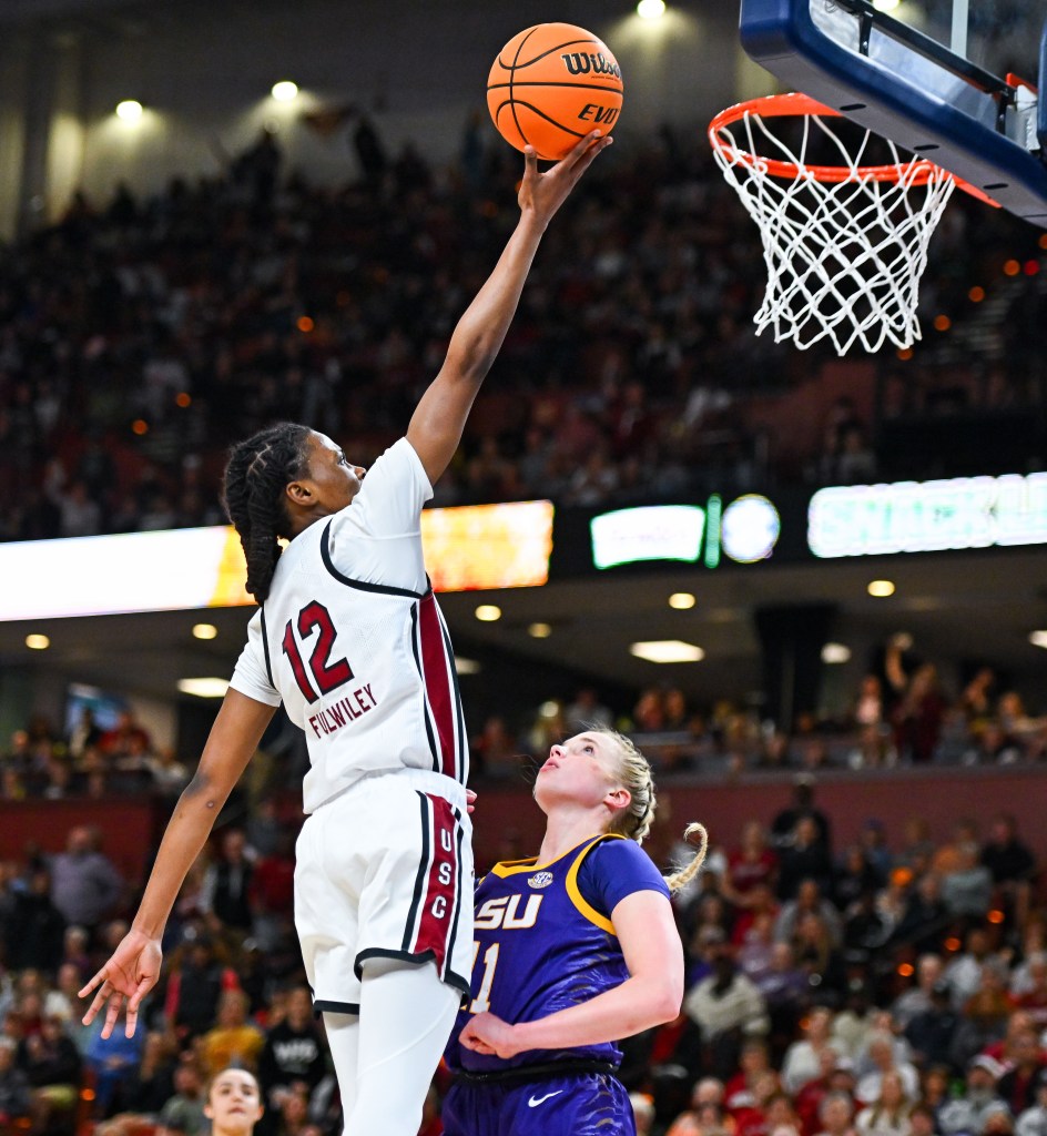 South Carolina's MiLaysia Fulwiley shoots a left-handed layup as an LSU defender arrives too late to get a hand up.