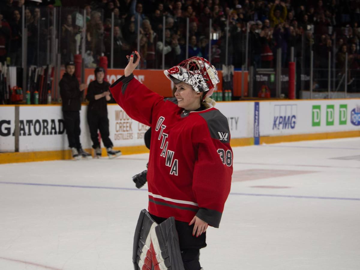 Goalie Emerance Maschmeyer waves to the crowd with a smile on her face.
