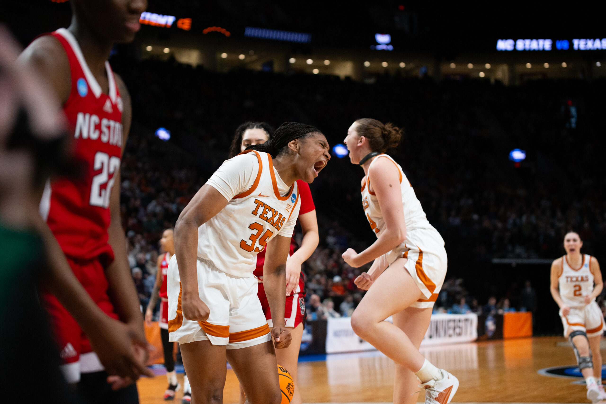 Texas forward Madison Booker is shown in profile. She yells in celebration after a basket.