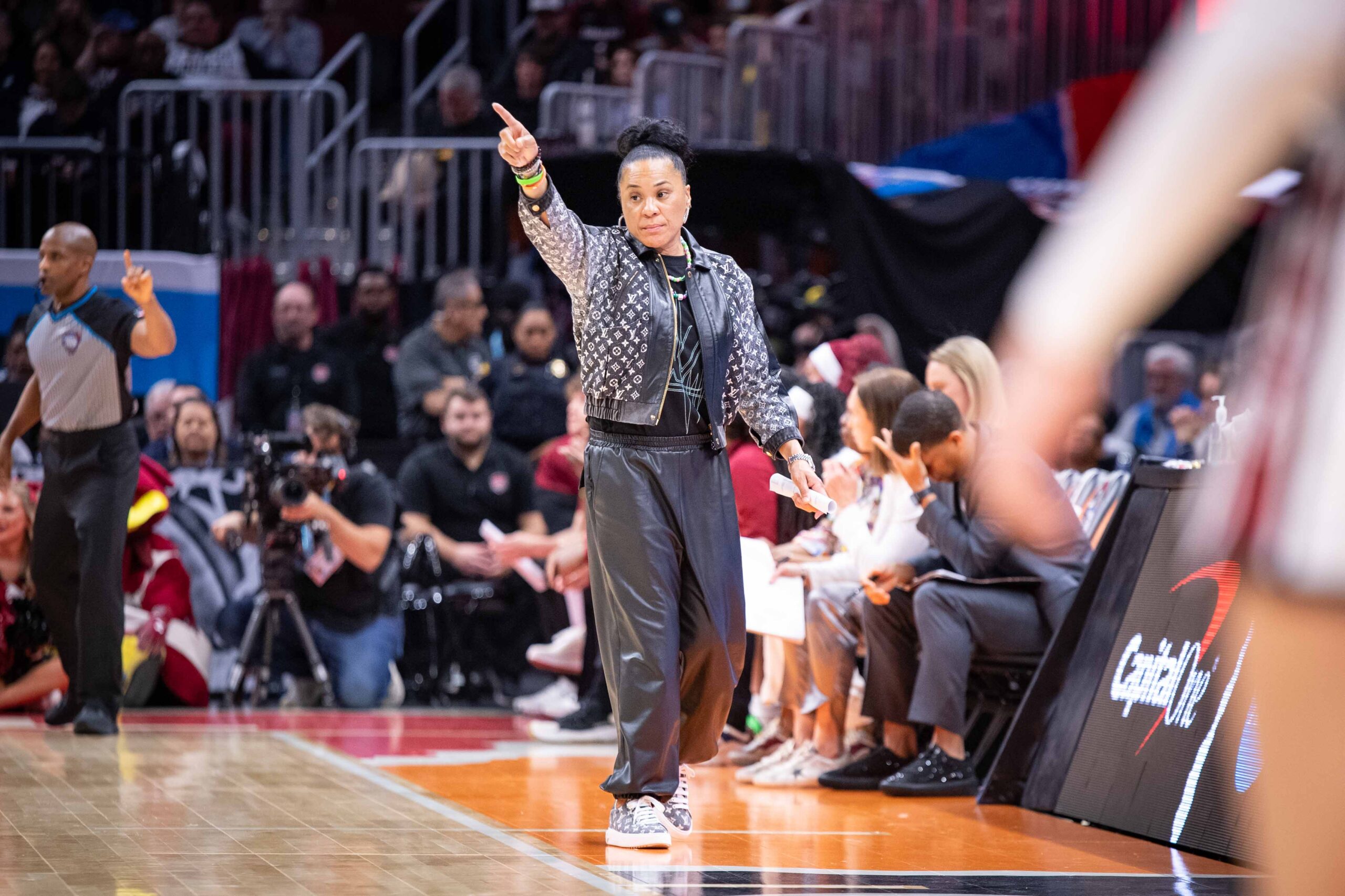 Staley is pictured with her arm raised pointing forward on the sideline