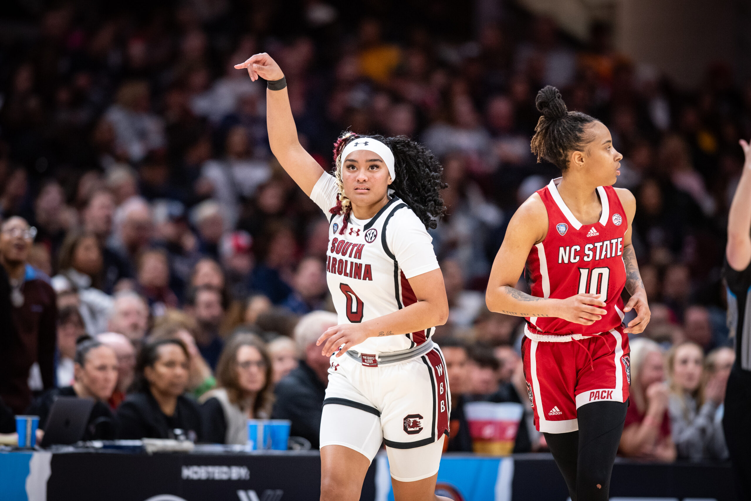South Carolina guard Te-hina Paopao signals up the court during a Final Four game against NC State. NC State's Aziaha James (10) runs beside her.